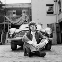 Mick Jagger photographed next to an Aston Martin DB6 car in London, 1966.