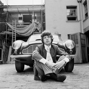 Mick Jagger photographed next to an Aston Martin DB6 car in London, 1966.