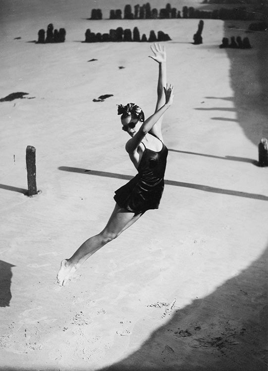 Pamela Minchin photographed on the Isle of Wight wearing Fortnum and Mason's dark burgundy Lastex satin swimsuit with ballet skirt, Harper's Bazaar, July 1939