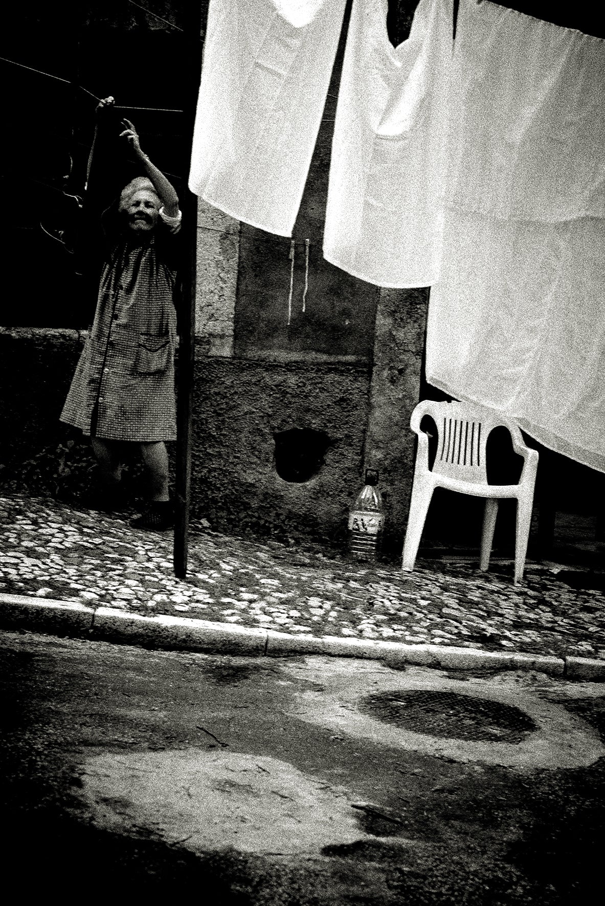 Woman hanging up laundry, Lisbon